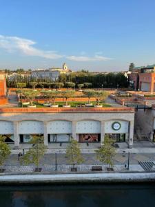 a large building next to a body of water at Cais 54 Apartments in Aveiro +15 photos