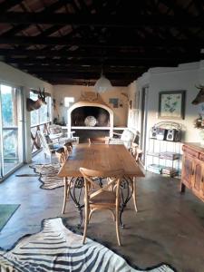 a dining room with a wooden table and chairs at Kaltenbach Cottages in Magoebaskloof