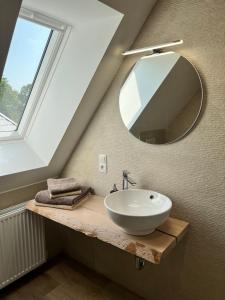 a bathroom with a sink and a mirror at Hotel Preyt -Self Check In- in Holtlander Nücke