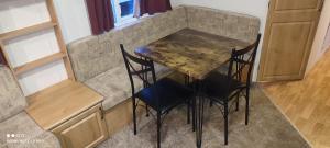 a table and chairs in a kitchen with a counter at Beachside, Family-friendly, WiFi, 6 berth Caravan 19 in Ingoldmells