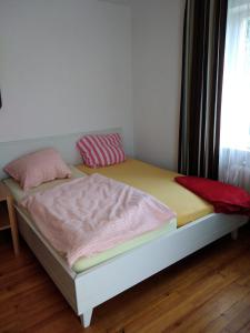 a bed with two pillows on it in a room at Zimmer nähe Festspielhaus/HBF in Bayreuth