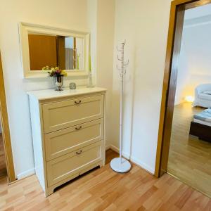 a dresser with a mirror and a dresser with a dresser at Nette Kuschelige Wohnung 2 in Bochum
