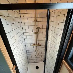 a shower with a shower head in a bathroom at The Travellers Rest in Newquay