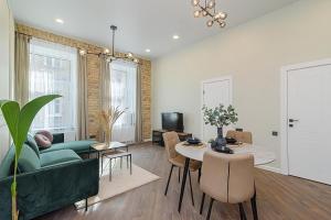 a living room with a couch and a table at FREE PARKING Old Town Central Station Apart with Balcony in Vilnius