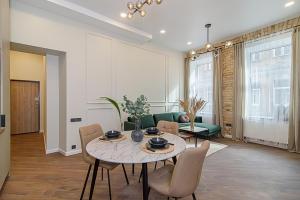 a living room with a table and a couch at FREE PARKING Old Town Central Station Apart with Balcony in Vilnius