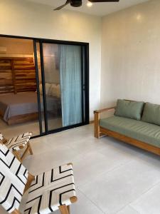 a living room with a couch and a bed at Ohana Villas in Santa Teresa Beach