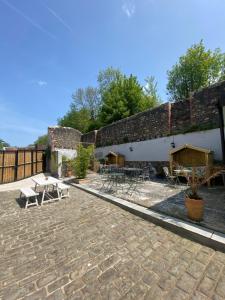 a patio with tables and chairs and a brick building at The Tiger Inn in Merthyr Tydfil
