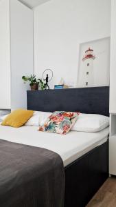 a bed in a room with a lighthouse in the background at Belvedere Premium in Novalja +64 photos