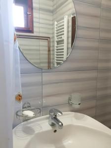 a bathroom with a sink and a mirror at Kod nane Cane in Nova Varoš