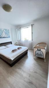 - une chambre avec un grand lit et une grande fenêtre dans l'établissement Apartment Marina, à Opatija