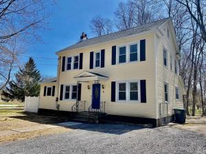 a white house with black windows and a door at Hidden Gem Secluded Home Steps from Bike Path in Schenectady