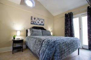 a bedroom with a large bed and a window at Hidden Gem Secluded Home Steps from Bike Path in Schenectady