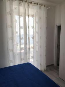 a bedroom with a blue bed and a window at VisitPonza - Olimpo in Ponza