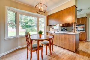 a kitchen with a wooden table and chairs and a window at Decatur Vacation Rental with Patio! in Decatur