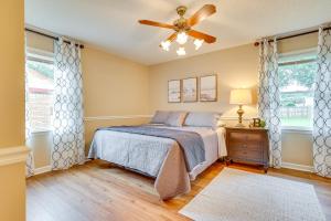 a bedroom with a bed and a ceiling fan at Decatur Vacation Rental with Patio! in Decatur
