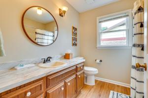 a bathroom with a sink and a mirror at Decatur Vacation Rental with Patio! in Decatur +16 photos