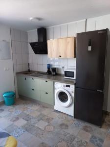 cocina con nevera y lavadora en LOFT EN PATIO DE CASA TÍPICA DE PUEBLO, en Villafranca de Córdoba
