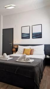 a bedroom with a large bed with two towels on it at Belvedere Premium in Novalja