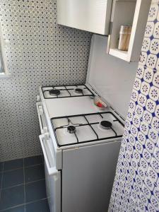 a kitchen with a stove top oven in a kitchen at VisitPonza - Olimpo in Ponza