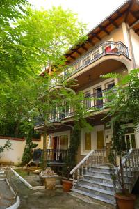 a building with stairs and a balcony on it at City Park Hostel in Pristina