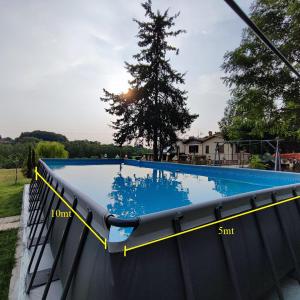 a swimming pool with a yellow tape around it at Masseria Le Querciole in Fauglia