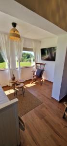 a living room with a couch and chairs and a table at Mini Hill - Tiny House in Gorušenjak