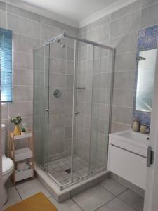 a shower with a glass door in a bathroom at Vacation at the Blyde Riverwalk Estate in Pretoria