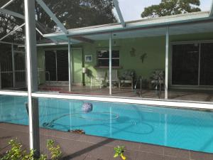 a house with a swimming pool with glass windows at Casa Limon with HEATED POOL in Sarasota