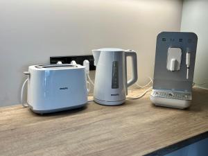 two toasters and a printer on a counter at Saue Apartment in Haapsalu