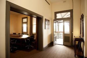 an office with a table and chairs and a door at Prince of Wales Hotel, Bunbury in Bunbury