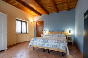 A bed or beds in a room at Agriturismo Cantine Bevione - Rooms with air conditioning