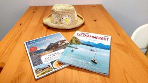 a table with two books and a hat on it at Markus Apartment in Strobl