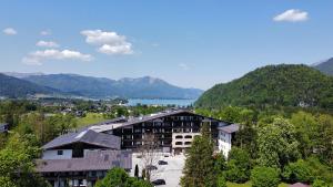 a building with a view of a lake and mountains at Markus Apartment in Strobl