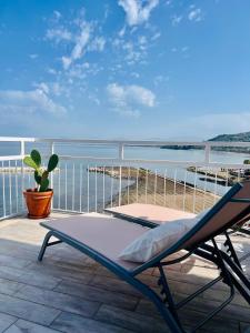a chair sitting on a patio with a view of the water at Sea La Vie - Terrazza sul mare in Agropoli +5 photos