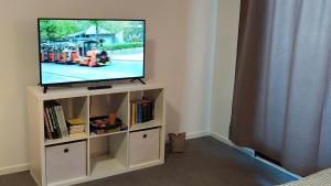 a flat screen tv sitting on top of a entertainment center at Markus Apartment in Strobl