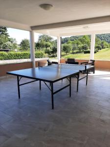 two ping pong tables sitting on a patio at Apartment Gorska vila in Ogulin