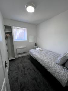 a small bedroom with a bed and a window at Marina Princes Reach 2 in Penwortham