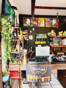 a shop with a desk with a laptop on it at Hostel Lumaria 1 in Blumenau