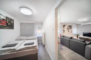 sypialnia z łóżkiem i salonem w obiekcie Centroom Pécs Apartman w mieście Pecz
