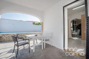 a dining room with a white table and chairs at Villa Rustical by MarCalma in Bonmont Terres Noves
