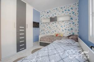 a bedroom with a bed and a blue wall at Villa Rustical by MarCalma in Bonmont Terres Noves +24 photos