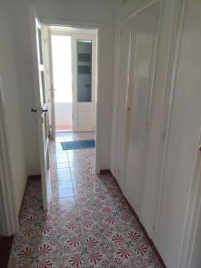 an empty hallway with a door and a tile floor at VisitPonza - Olimpo in Ponza