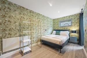 a bedroom with a bed and a tub in it at Stunning 3 bed 2 bathroom BASEMENT flat in earls court, London in London