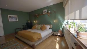 a bedroom with a bed with a green wall at 3 Bedroom Apartment in Polanco - best location in Mexico City