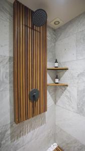 a bathroom with a shower with a wooden wall at 3 Bedroom Apartment in Polanco - best location in Mexico City