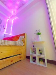 a bedroom with a bed and a purple ceiling at The Celandine Residences By HJM in Manila