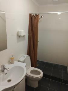 a bathroom with a white toilet and a sink at Ohana Boutique in Astana +15 photos
