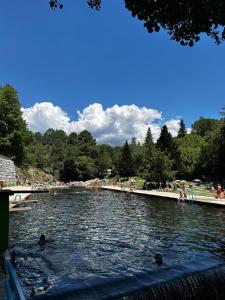 a group of people swimming in a body of water at SolGredos in Arenas de San Pedro