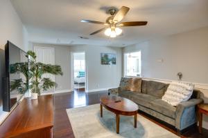 a living room with a couch and a ceiling fan at Luxe San Antonio Vacation Rental with Private Pool! in San Antonio