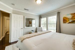 a bedroom with a large white bed and a window at Luxe San Antonio Vacation Rental with Private Pool! in San Antonio +27 photos